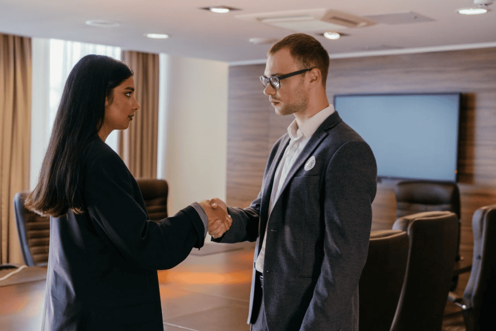 two professionals shaking hands indoors